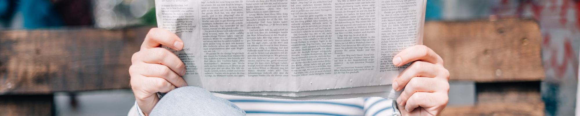 Person reading a newspaper
